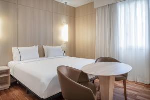 A bed or beds in a room at AC Hotel Málaga Palacio by Marriott