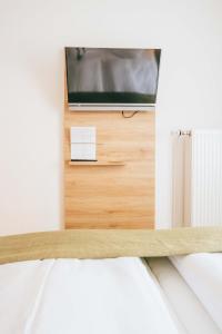 a bed with a tv on top of a table at Hotel Andres in Bamberg