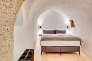 Una cama o camas en una habitación de Boutiquehotel Rattenberg