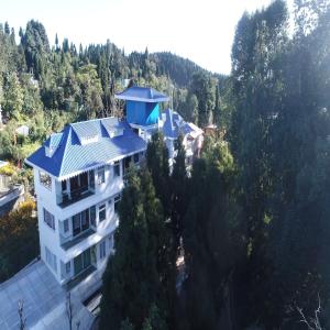 een luchtzicht op een huis met een blauw dak bij Amaira Resort & Farms - Mirik, West Bengal in Mirik