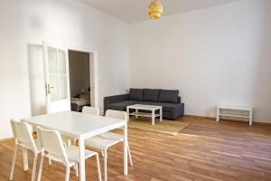 a living room with a white table and chairs at Vienna City Apartments 1090 Vienna in Vienna