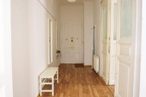 a hallway with a wooden floor and a white door at Vienna City Apartments 1090 Vienna in Vienna