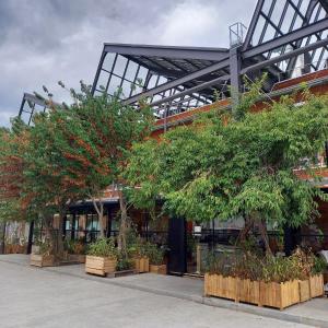 a building with trees and plants in front of it at Auberge de Jeunesse HI Paris Yves Robert in Paris