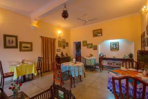 a dining room with two tables and chairs at Rawla Rawatsar in Jaipur