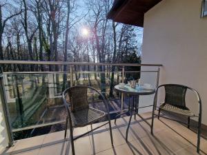 a balcony with two chairs and a table on a balcony at Villa Cristal in Świnoujście