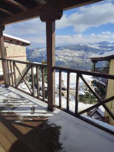 uma vista da varanda de uma casa na neve em Evergreen Suites em Synikia Mesi Trikalon