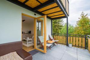 a screened in porch with a view of a house at AKORD chata in Námestovo