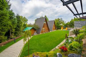 a house in the woods with a lawn at AKORD chata in Námestovo