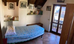 a bedroom with a bed and a glass door at Casa vacanze Ravascletto in Ravascletto