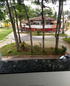 a view from a window of a house with trees at Pousada Sol e Cia Tur in Caraguatatuba