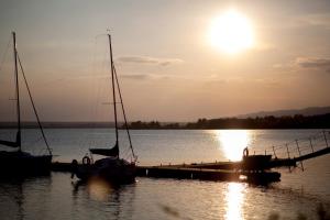 two boats are docked at a dock in the water at Willa Jordanówka in Czorsztyn