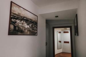 a picture hanging on a wall next to a hallway at Hotel Castrum in Skopje