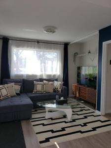 a living room with a blue couch and a tv at 2plex, Choose, 1of 2 entire units apparts in Hamilton