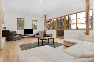 a living room with two couches and a tv at Apartmán Ela in Horní Blatná