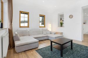 a living room with a couch and a table at Apartmán Ela in Horní Blatná