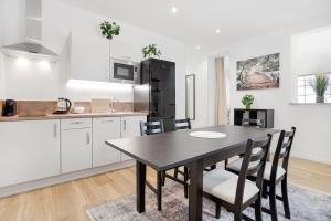 a kitchen with a table and chairs in a room at Apartmán Ela in Horní Blatná