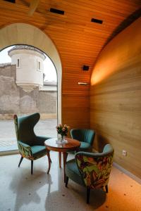 a room with three chairs and a table and a window at Hotel La Briosa in Bolzano