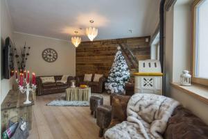 a living room with a christmas tree in it at Residence Aspen in Arabba