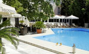 a swimming pool with two toy ducks in the water at Theoxenia Palace in Athens