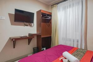 Телевизор и/или развлекательный центр в Taxa Uma Guest House