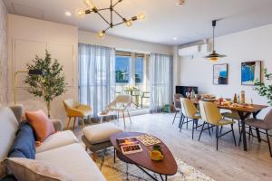 a living room with a couch and a table at Southerlies Condominium Onna in Onna