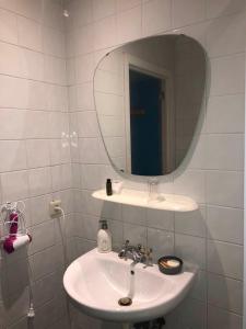 a white bathroom with a sink and a mirror at Les Lumerettes - Dohan in Bouillon