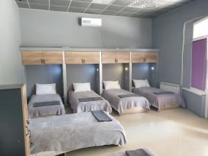 a room with four beds in a room at Мандри Хостел in Uzhhorod