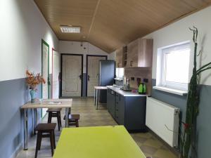 a kitchen with a table and a yellow counter top at Мандри Хостел in Uzhhorod