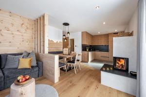 a living room with a couch and a fireplace at Apartment Mittermanting in Villnoss