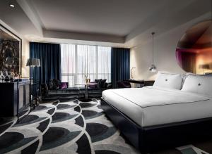 A bed or beds in a room at Bisha Hotel Toronto