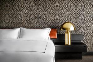 A bed or beds in a room at Bisha Hotel Toronto