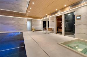 a large room with a swimming pool in a building at Hotel Bowmann in Paris