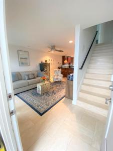 a living room with a couch and a staircase at Bay Beach Bungalow in San Diego