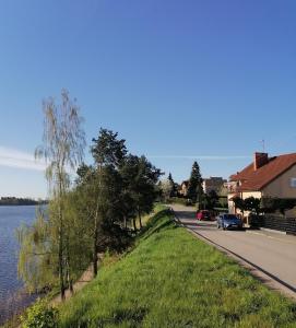 droga obok zbiornika wody z domem w obiekcie Apartament Wschód Słońca Olecko w mieście Olecko