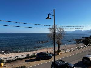 un feu de rue sur une route à côté de l'océan dans l'établissement Fronte mare, à Cala Gonone