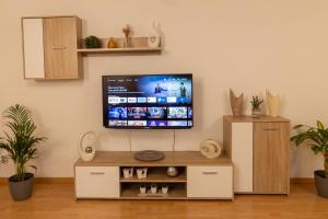 a living room with a flat screen tv on a wall at Ferienwohnung am Bach in Oberkotzau