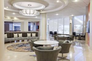 a lobby with chairs and tables and a chandelier at Tampa Airport Marriott in Tampa