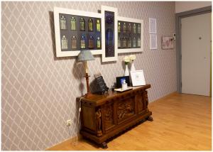 a room with a table with a lamp and bottles on the wall at Luengo House in León