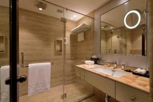 a bathroom with a sink and a mirror at Taj Krishna in Hyderabad