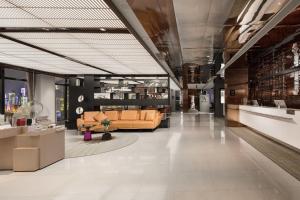 a lobby with couches and tables in a building at Atour Hotel Chongqing Jiefangbei Raffles City Riverview in Chongqing