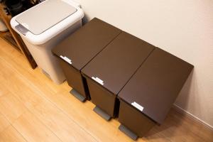 a table with two boxes next to a toilet at Y's沖縄リゾートベースNo.2 in Onna