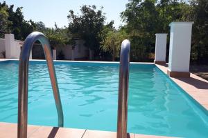 a swimming pool with two metal poles in the water at Quinta da Ponte das Hortas 1 in Elvas