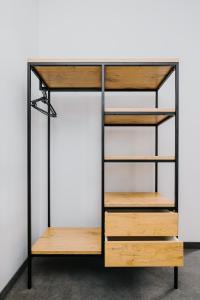 a book shelf in a room with wooden shelves at Obiekt Noclegowy OCELOT II in Pruszków