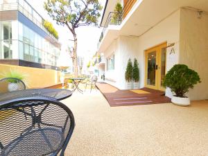 a patio with a table and chairs on a building at OYO Myeongdong 5 Lodge in Seoul