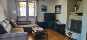 a living room with a couch and a fireplace at Apartmaji Ri-100 in Portorož