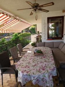 a patio with a table and chairs and a ceiling fan at Apartmaji Ri-100 in Portorož