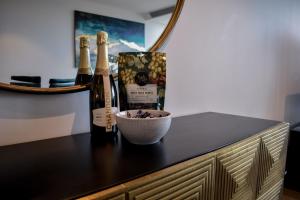 un bancone con due bottiglie di vino e una ciotola di Deluxe 3 Bedroom Apartment in Southbank a Melbourne