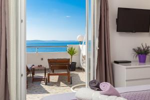 a hotel room with a view of the ocean at Sky Way Apartments in Dugi Rat