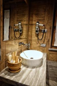 a bathroom with a white sink and a counter at Café Quinson Relais de Charme in Morgex