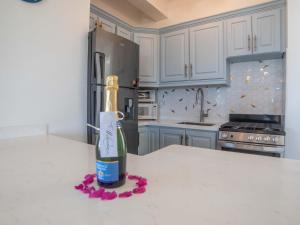 a bottle of wine sitting on a counter in a kitchen at Antigua Village Beach Resort in Saint Johnʼs